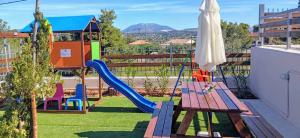 a playground with a slide and a bench on a balcony at Villa Angelo Porto Heli - Private Pool in Porto Heli