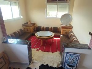 a living room with a couch and a table at Gite touristique bouknala in Abinane