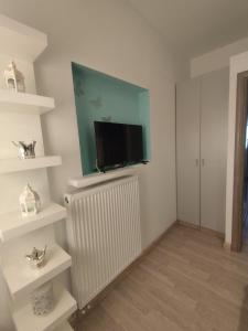 a living room with a flat screen tv on a radiator at Isaias house in Rhodes Town