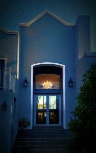 a blue house with a window and a chandelier at Belle Vie Boutique Guesthouse in Pretoria