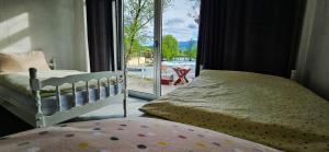 a bedroom with a bed and a window with a view at Apartment Bijela ladja in Bihać