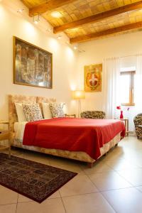 a bedroom with a large bed with a red blanket at kis inn affitacamere guesthouse in Rome