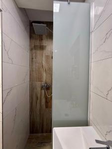 a bathroom with a shower and a white sink at Residence La Femme in Tuzla +26 photos