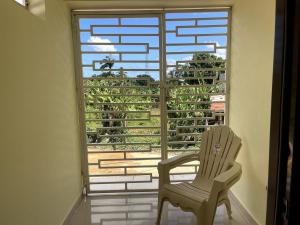 a room with a chair and a large window at Apartamento Costero 2 en Las Galeras in Las Galeras