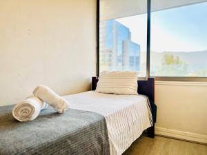 Una cama o camas en una habitación de Moderno a pasos de Parque Arauco
