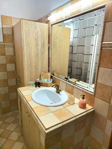 a bathroom with a sink and a large mirror at Mountain paradise in Elevtheraí +57 photos