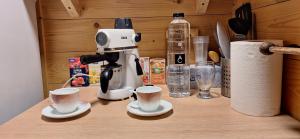 a coffee maker and two cups on a counter at Cabana Plaiul Bucovinei in Câmpulung Moldovenesc +17 photos