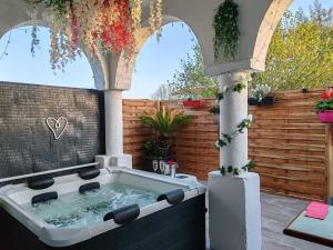 un jacuzzi en un patio trasero con una valla en Romance à l' affiche, en Valence-dʼAgen