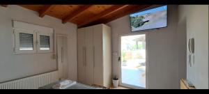 a living room with a tv on the wall at Baulus Yard Luxury I in Heraklio Town