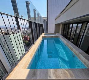 a swimming pool on the roof of a building at Comfortable apartment in Reforma, downtown CDMX in Mexico City