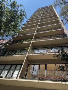 a tall apartment building with balconies and trees at Comfortable apartment in Reforma, downtown CDMX in Mexico City