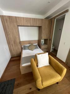 a bedroom with a bed and a chair at Comfortable apartment in Reforma, downtown CDMX in Mexico City +11 photos