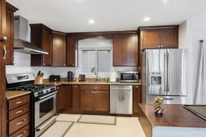 a kitchen with wooden cabinets and stainless steel appliances at Well appointed Lakefront home in White Lake +20 photos