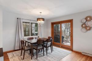 a dining room with a table and chairs at Well appointed Lakefront home in White Lake
