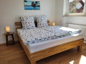 a bedroom with a bed with a wooden frame at Ferienwohnung Ankerplatz Wangen in Öhningen