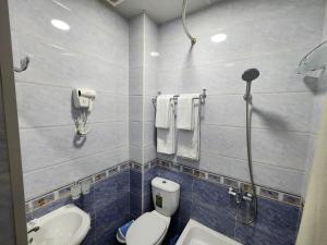 a bathroom with a toilet and a sink at Muhtasham Hotel in Ichan Qala in Khiva