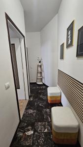 a hallway with two stools and a ladder in a room at Alloggio Desiri 2 in Pavia