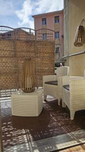 a patio with wicker chairs and tables on a balcony at Alloggio Desiri 2 in Pavia +4 photos