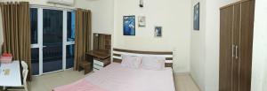 a small bedroom with a bed and a window at WRX guest house in Hanoi