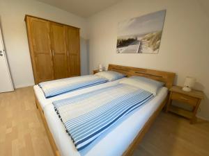 フレンスブルクにあるFerienwohnung Parkgartenの木製のヘッドボードが付いた大きなベッドのある寝室