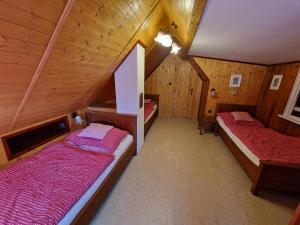 a room with two beds in a attic at Chata Libošovice 109 in Libošovice +29 photos