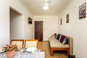 un soggiorno con un divano e un tavolo di A2-CantoForte - 200 metrosPraia - ARCond - Garagem - Wifi - Ideal para Família a Praia Grande