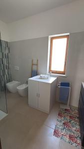 a bathroom with a sink and a tub and a toilet at Villa Ingrosso in Leporano Marina +14 photos