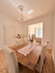 a dining room with a wooden table and chairs at Villa Rheinblick 1 OG in Kamp-Bornhofen +17 photos