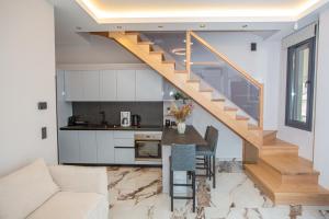 a staircase in a living room with a table and a kitchen at City View Loft in Ioannina