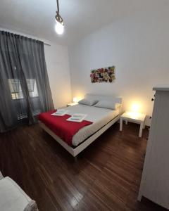 a bedroom with a bed with a red blanket at Maison 18 in La Spezia