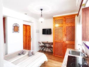 A television and/or entertainment centre at El Beaterio Apartments