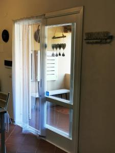 an open door to a room with a window at Live Sea and Nature in Costa Paradiso