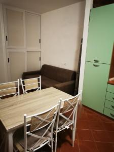 a table and chairs in a living room with a couch at Live Sea and Nature in Costa Paradiso
