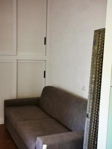 a couch in a living room with white walls at Live Sea and Nature in Costa Paradiso +33 photos