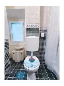 a bathroom with a toilet and a window at Apartments Senko in Trpanj +80 photos