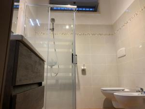 a bathroom with a shower and a toilet and a sink at NEW piscina coppa di fuoco in Fasano +25 photos