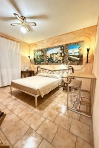 a bedroom with a bed and a stone wall at B&B Sa Bèrtula in La Maddalena
