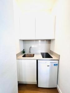 A kitchen or kitchenette at El Beaterio Apartments