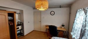 a room with a desk and a clock on the wall at Beethoven Homestay in Eindhoven