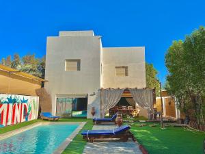a house with a swimming pool in front of it at American Villa Dahab in Dahab