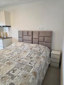 a bedroom with a bed with a comforter at Dream - sea view apartment in Pučišća