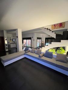 a living room with a large couch and a staircase at American Villa Dahab in Dahab +140 photos