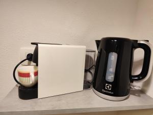 a black and white coffee maker and a coffee pot on a counter at Dream - sea view apartment in Pučišća