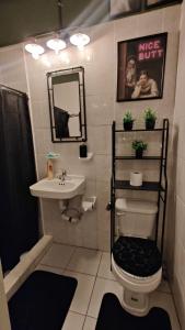 a bathroom with a sink and a toilet and a mirror at Frida Downtown Apart in Playa del Carmen