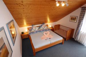 a bedroom with a bed with a pink butterfly on it at Ferienwohnung Victoria mit schöner Aussicht - Mein Schwarzwaldhäusle in Todtmoos +17 photos
