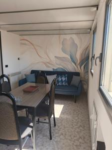 a dining room with a table and a couch at Cozy Apartments in Lido di Ostia