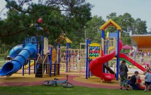 a playground with kids playing on a slide at Cozy apartment in Ventspils