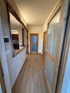 a hallway leading to a kitchen with a glass door at La Ca d'Marietta in Paesana