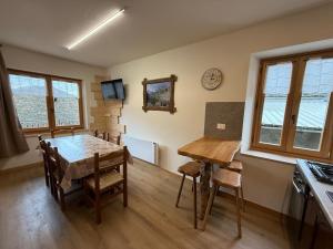 a kitchen and dining room with a table and chairs at La Ca d'Marietta in Paesana