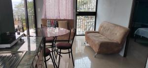 a living room with a table and a couch at Bella vista Ceci B1 in San Ramón